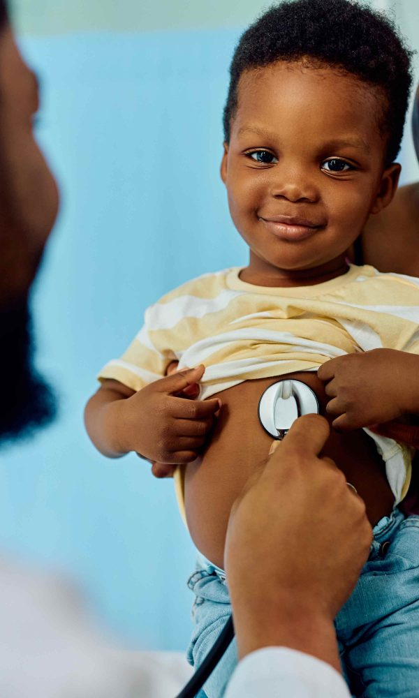 Smiling black boy during medical checkup at pediat 2026 01 06 10 28 02 utc 1001 600x1000